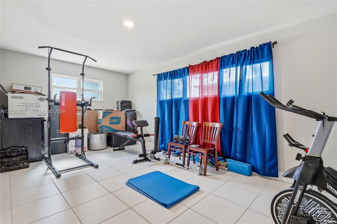 Room featuring ceramic tile flooring, neutral wall paint, and recessed lighting, with windows providing natural light