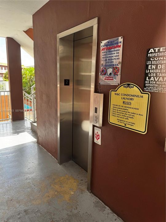 Stainless steel elevator with a brushed metal finish and metal railings