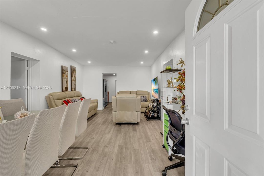 Entryway featuring wood-finish flooring and recessed lighting