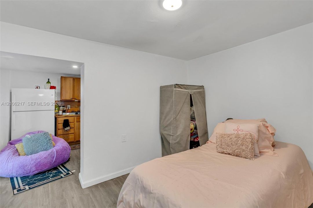 Neutral-toned wood-finish flooring and flush-mount ceiling lighting
