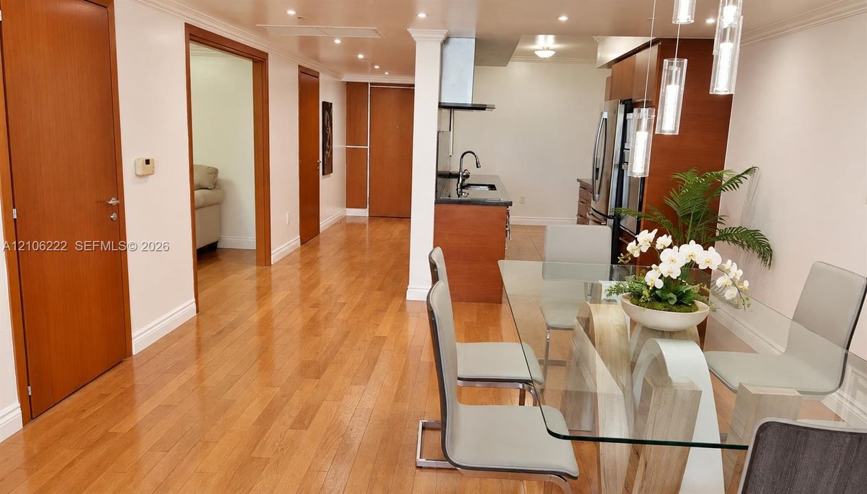 Interior featuring wood-finish flooring, recessed lighting, and kitchen cabinetry with integrated stainless steel appliances