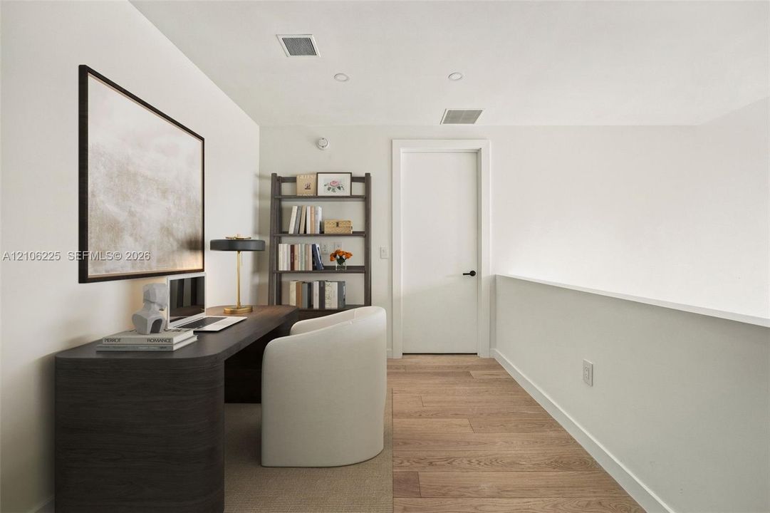 Wood-finish flooring, recessed lighting, and a solid-core interior door with matte black hardware