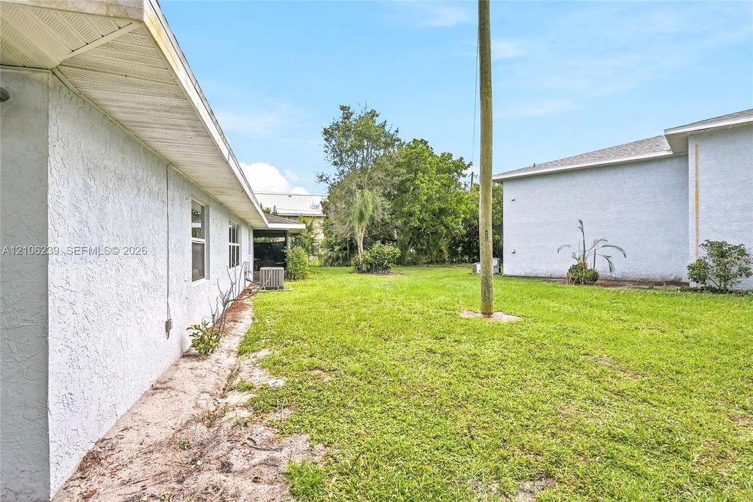 Stucco exterior finishes, overhanging eaves, and expansive grass lawn