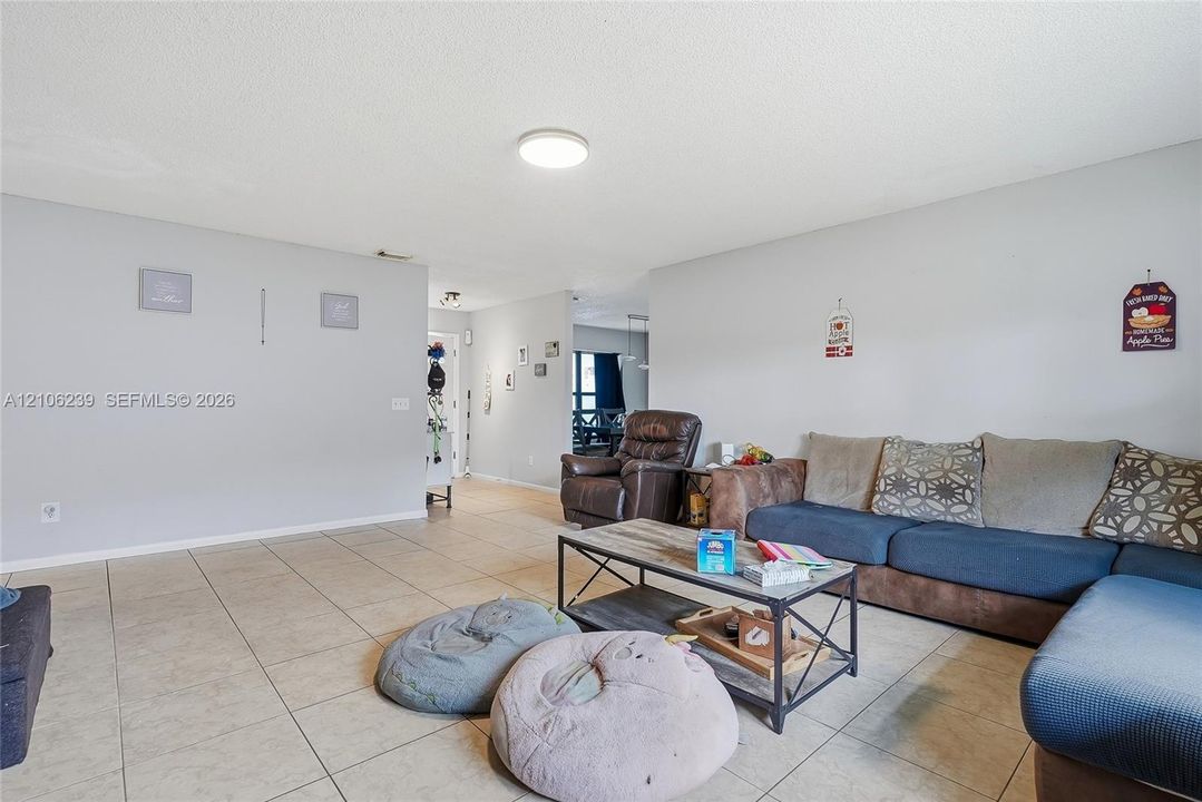 Neutral interior space featuring neutral wall paint and ceramic tile flooring throughout