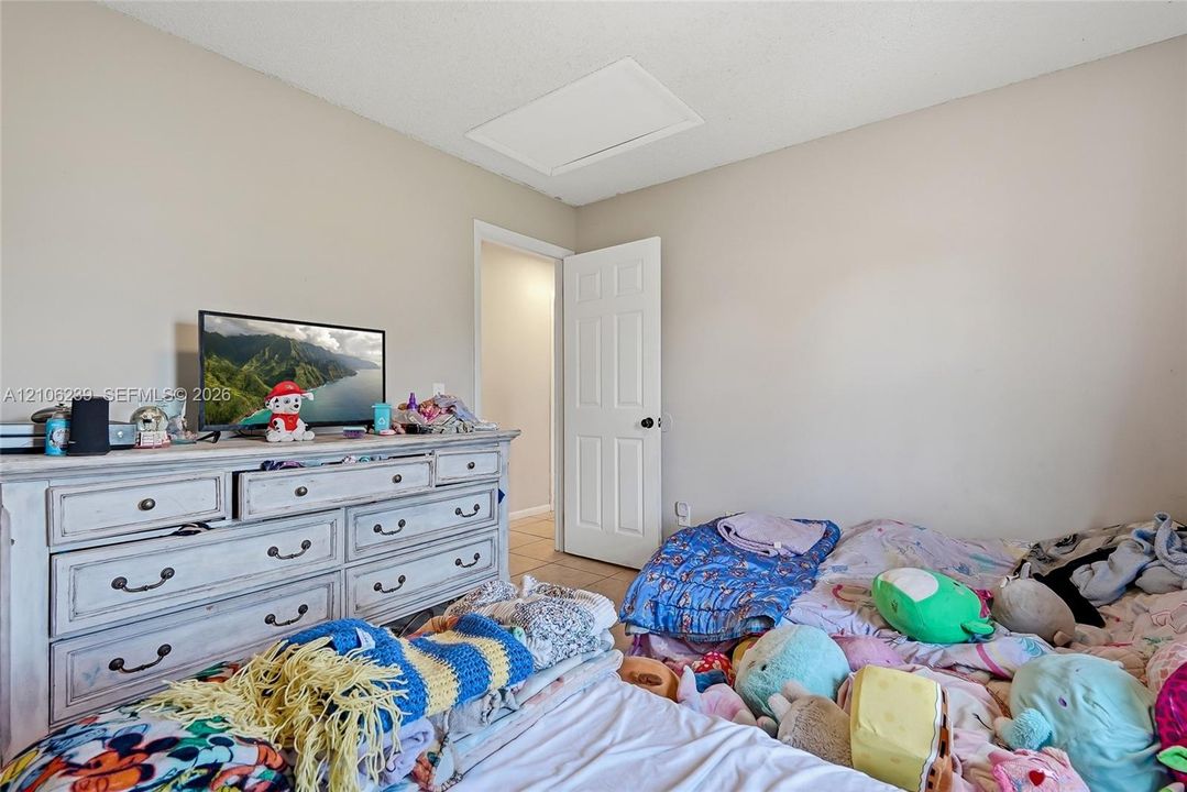 Neutral wall color, ceiling access panel, and white six-panel door