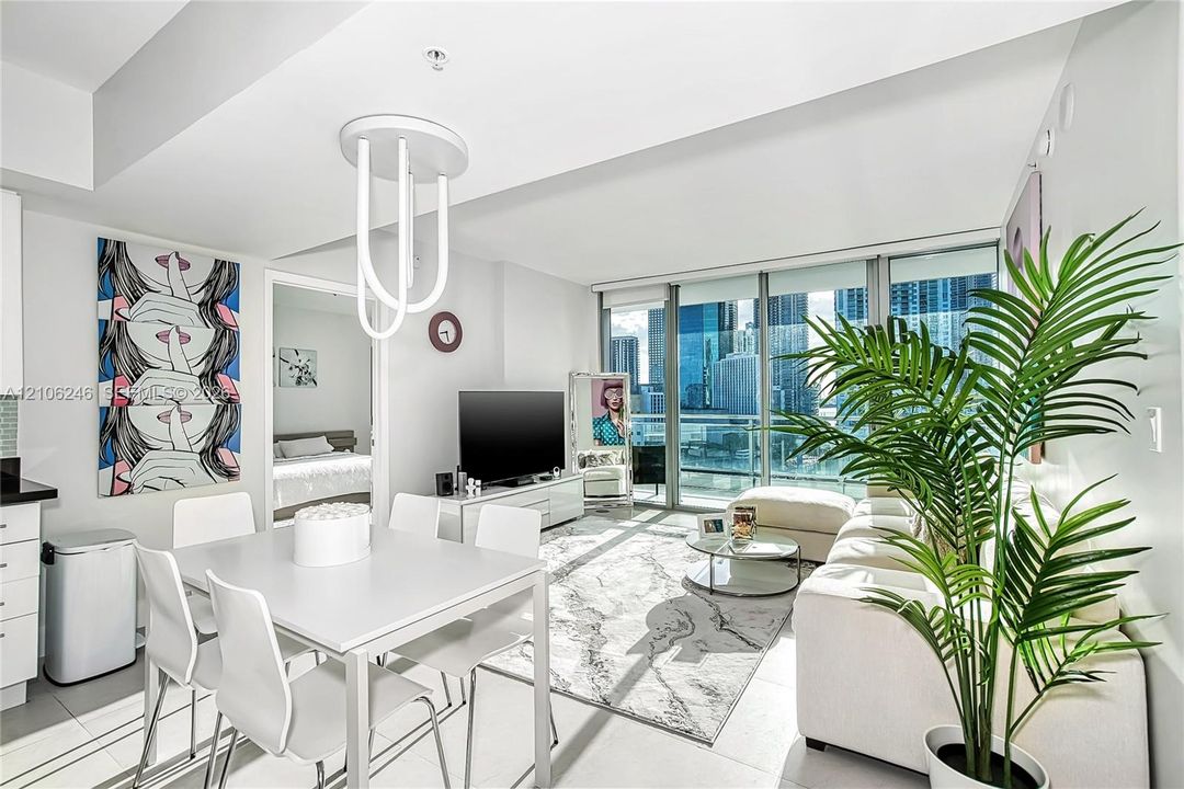 Open-concept living space featuring floor-to-ceiling windows, porcelain tile flooring, and custom modern pendant lighting
