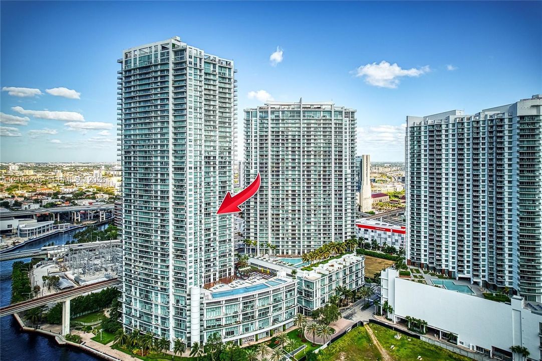 High-rise glass facade featuring wraparound balconies and a central concrete structural design