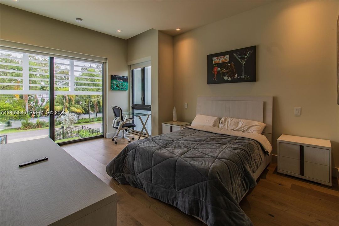 Floor-to-ceiling sliding glass door, wood-finish flooring, recessed lighting, and neutral wall tones