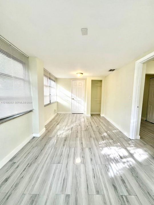 Porcelin Wood-finish flooring, multi-pane windows with horizontal blinds, and a built-in recessed storage area