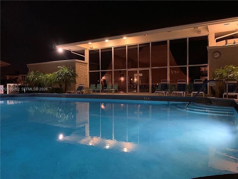 In-ground swimming pool featuring a stepped entry and concrete decking