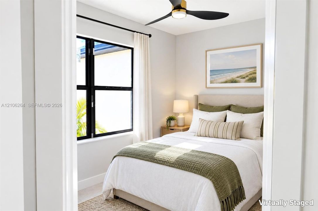 Black-framed window with exterior greenery, modern ceiling fan with integrated lighting, and neutral wall tones