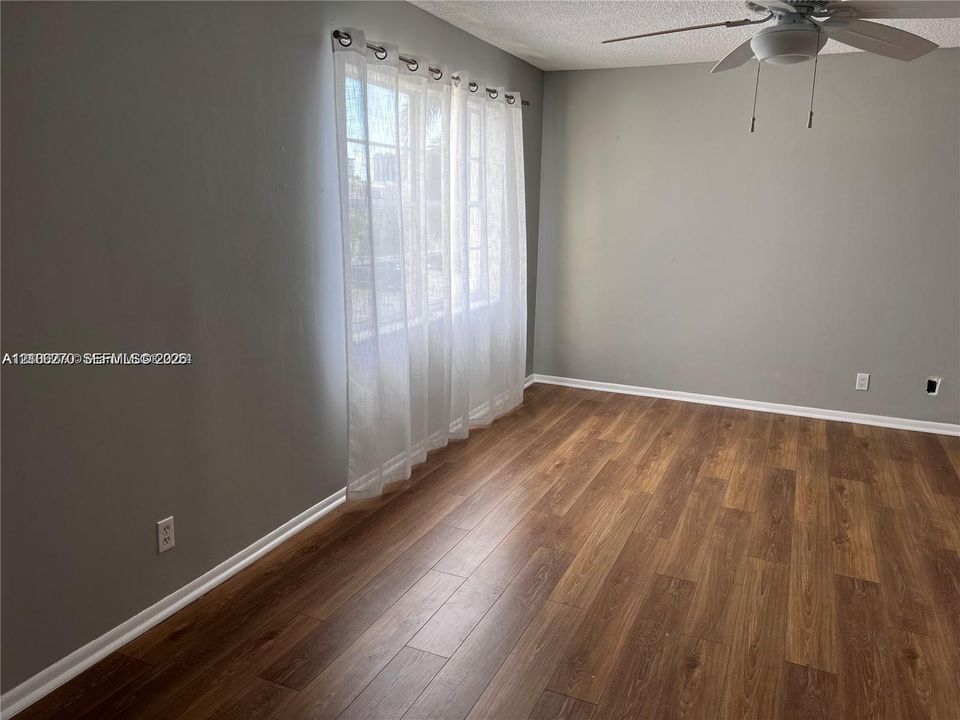Wood-finish flooring, multi-pane window, and ceiling fan