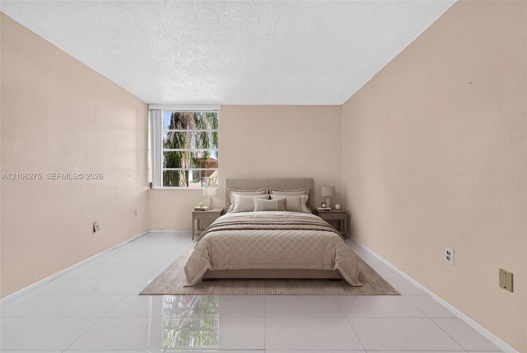 Neutral-toned interior room featuring large-format tile flooring, textured ceiling finish, and a rectangular window