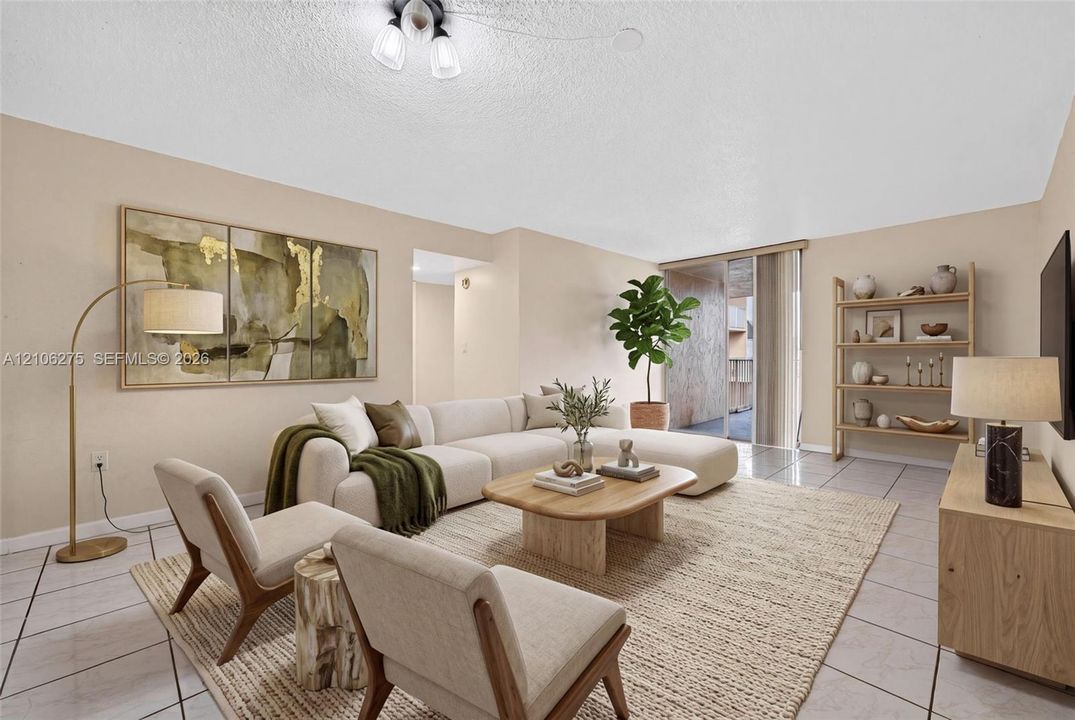 Neutral-toned interior featuring ceramic tile flooring, a multi-arm flush mount ceiling fixture, and a sliding glass door leading to an outdoor balcony