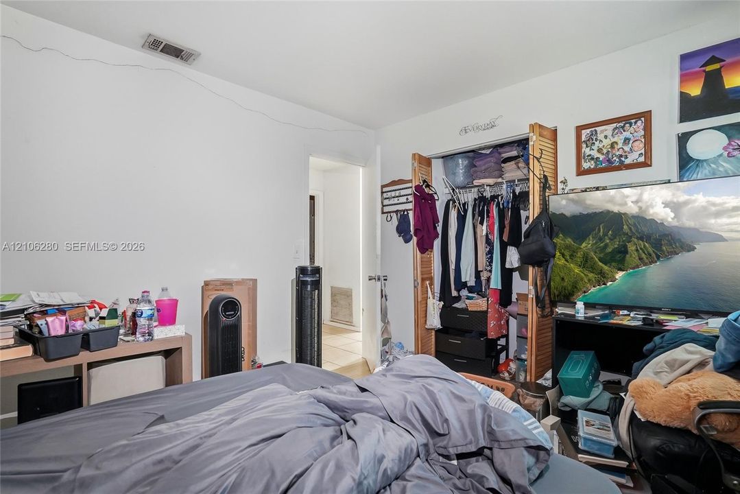 Interior space featuring a reach-in closet with bi-fold wooden louvered doors