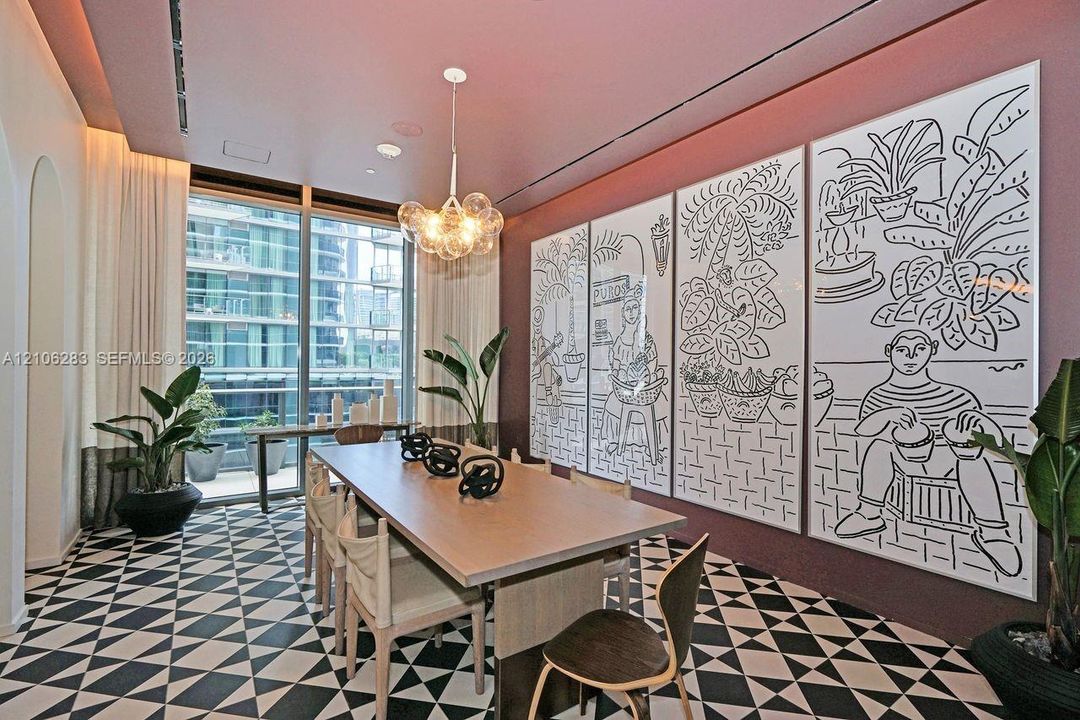 Geometric patterned tile flooring, floor-to-ceiling glass windows, recessed ceiling lighting, and a multi-globe pendant light fixture
