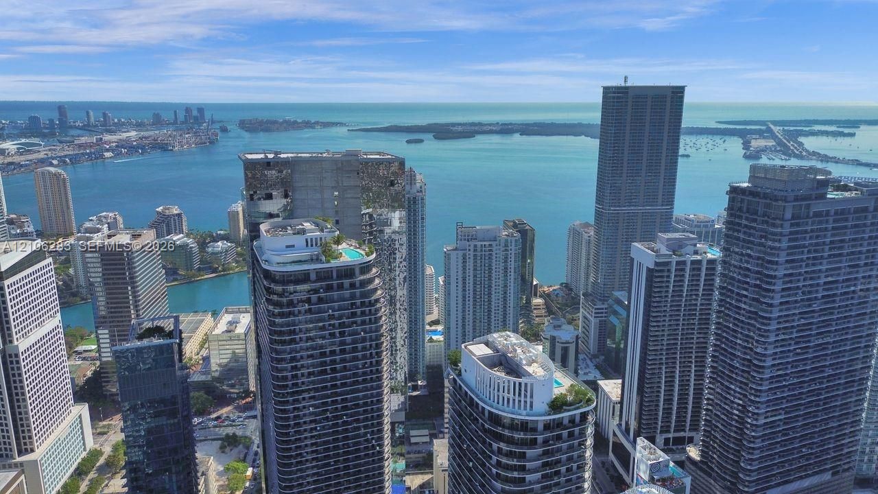 High-rise aerial perspective featuring an expansive urban skyline and prominent waterfront access