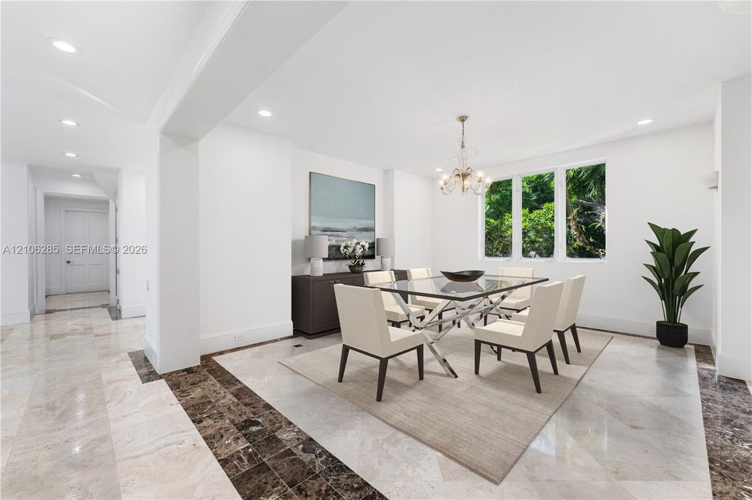 Dining area featuring recessed lighting, multi-paned windows, and stone tile flooring with a decorative dark stone border