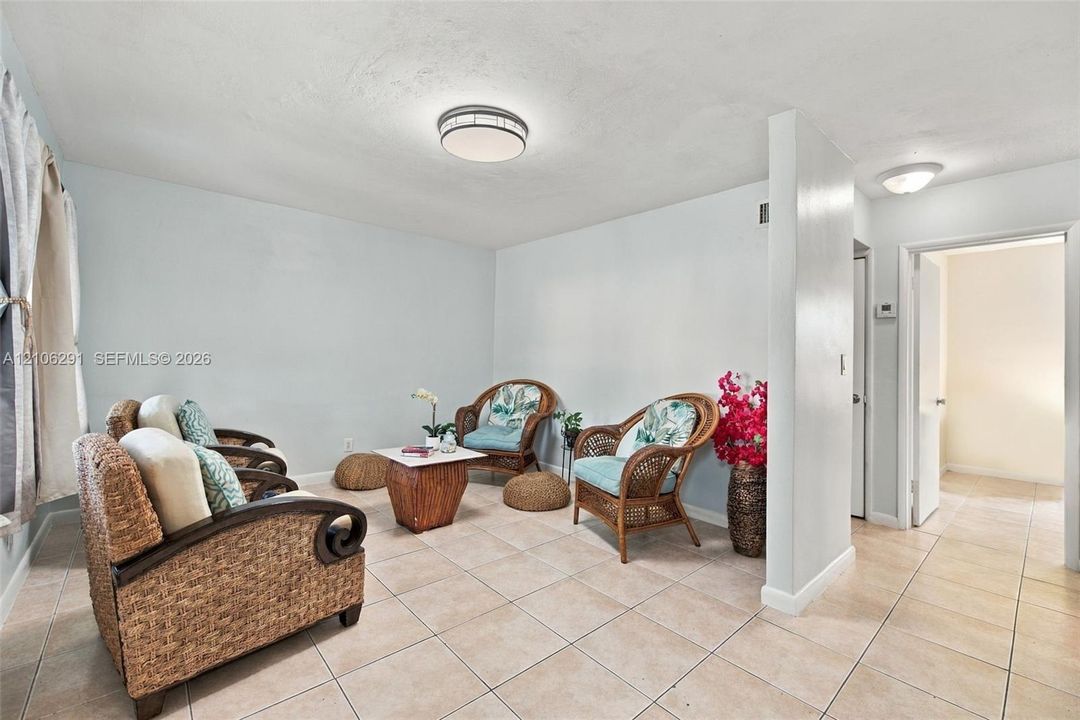 Neutral ceramic tile flooring, rounded flush-mount ceiling lighting fixtures, and solid-core interior doors