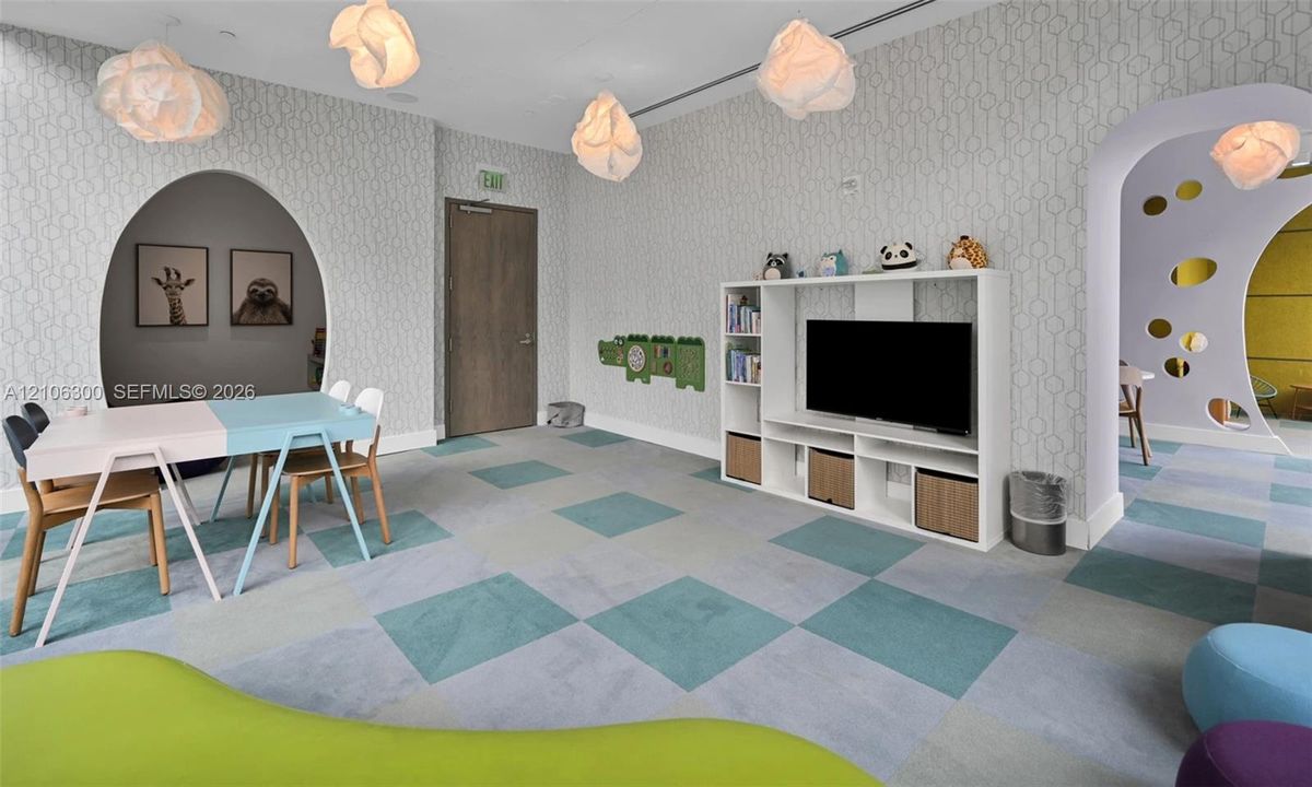 Geometric wallpaper, checkerboard pattern flooring, integrated white shelving unit, and custom arched entryways