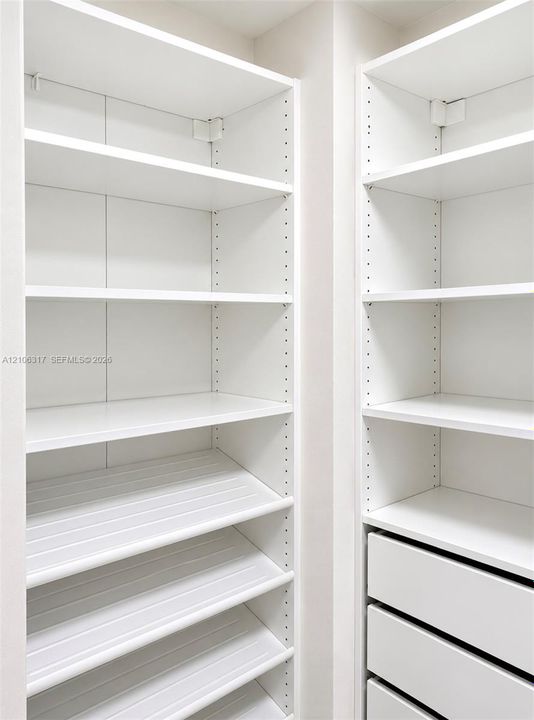 Custom white shelving system featuring adjustable heights, integrated storage drawers, and specialized angled shoe storage shelving