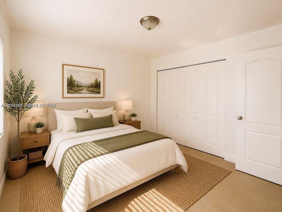 Neutral interior featuring tile flooring, a multi-panel door, and a spacious floor-to-ceiling closet with bi-fold doors
