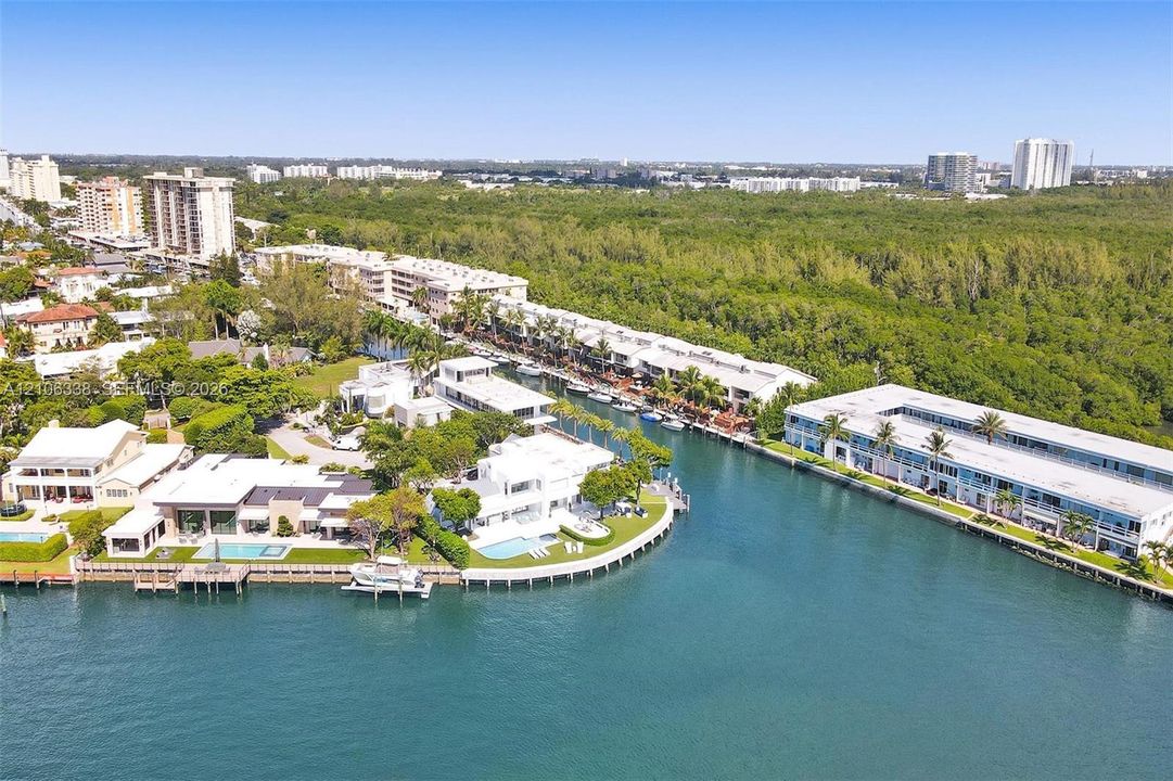 Waterfront residential property featuring private deep-water dockage, paved bulkhead, swimming pools, and manicured landscaping