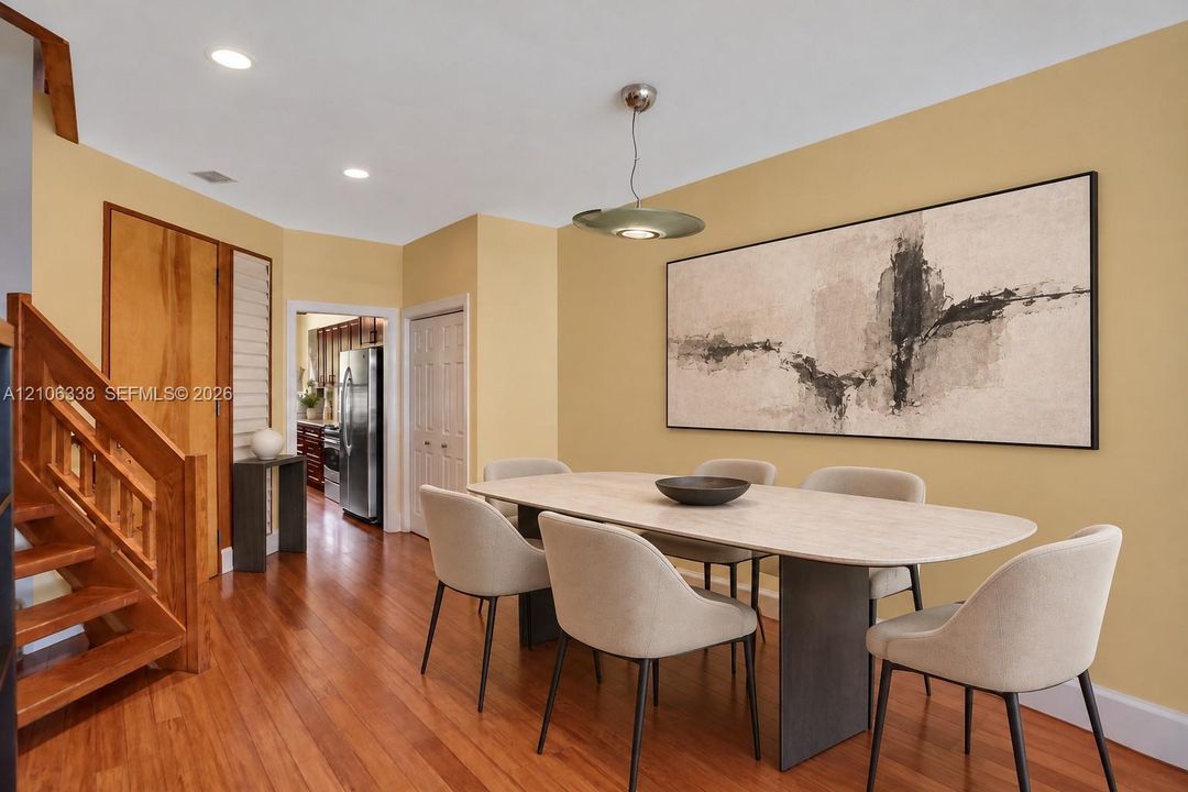 Interior featuring wood-finish flooring, recessed lighting, and a custom wood staircase with matching railing