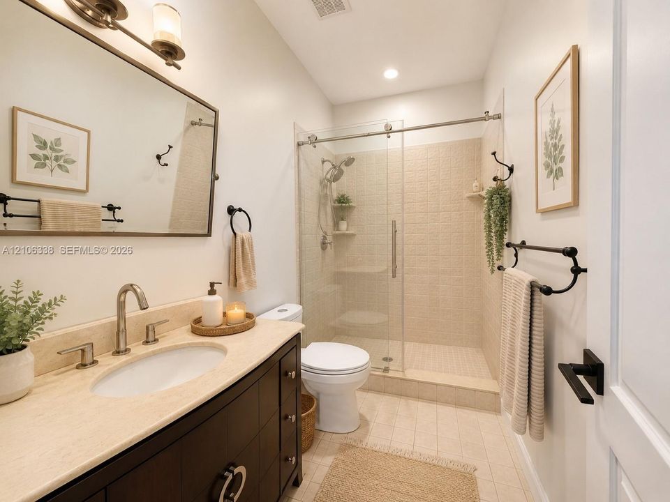 Bathroom featuring a dark-finish vanity with a neutral stone countertop, undermount sink, walk-in shower with sliding glass doors, and matte black hardware