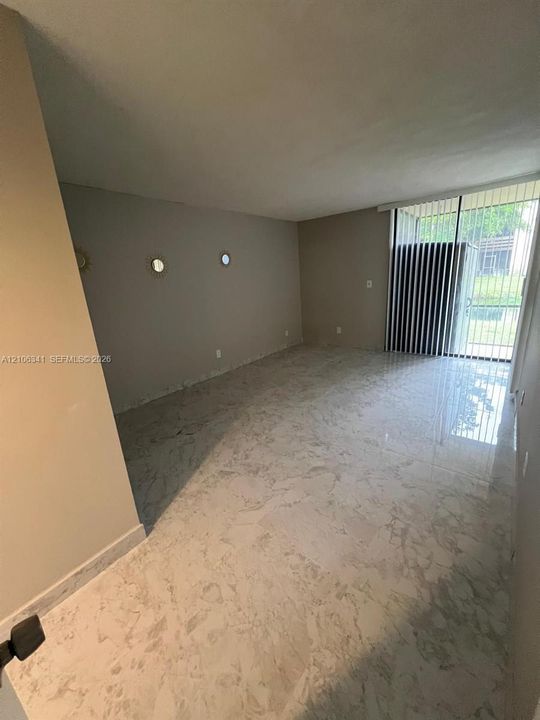 primary bedroom w full bathroom and sliders to screened porch  that overlooks canal