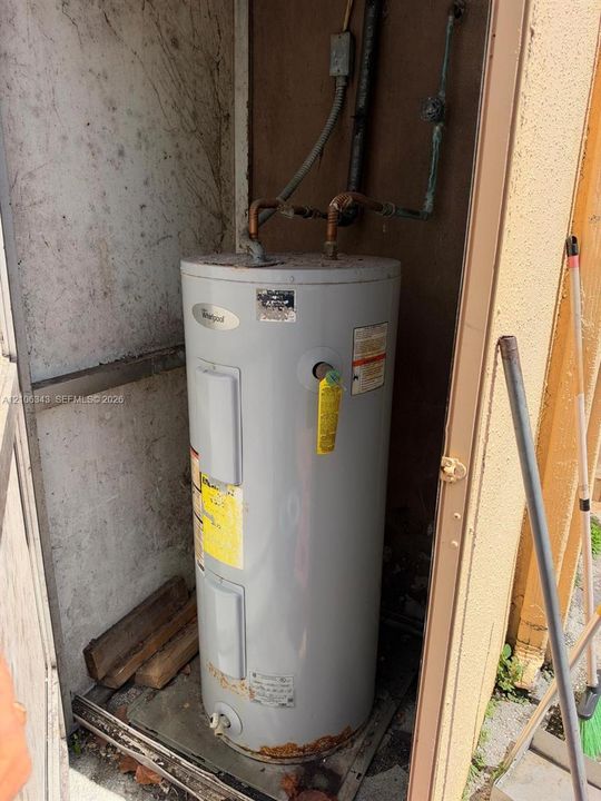 Whirlpool electric water heater housed within an exterior utility enclosure