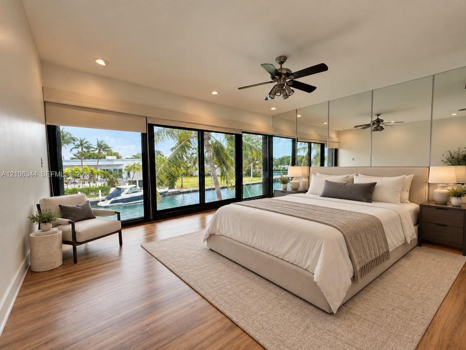 Floor-to-ceiling sliding glass doors, wood-finish flooring, mirrored wall accents, recessed lighting, and a multi-blade ceiling fan