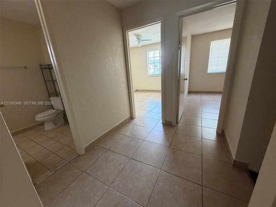Ceramic tile flooring, white-finish interior doors, and window treatments