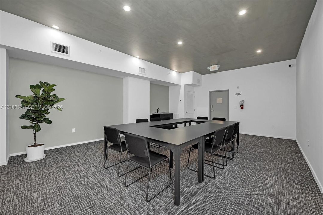 Neutral-toned interior featuring a recessed ceiling, recessed lighting, and patterned carpeted flooring