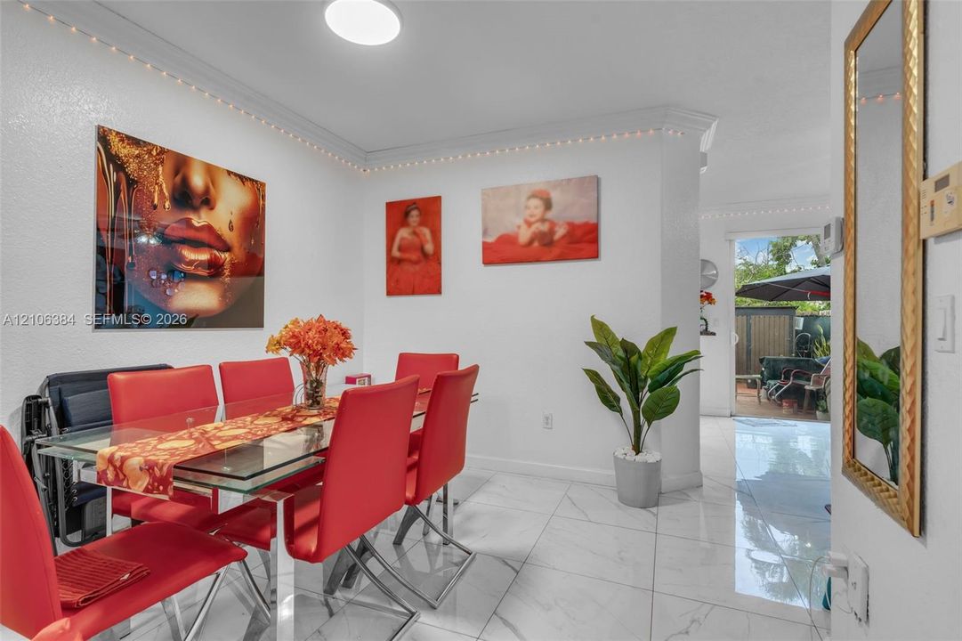 Large-format tile flooring, neutral wall finish, and crown molding