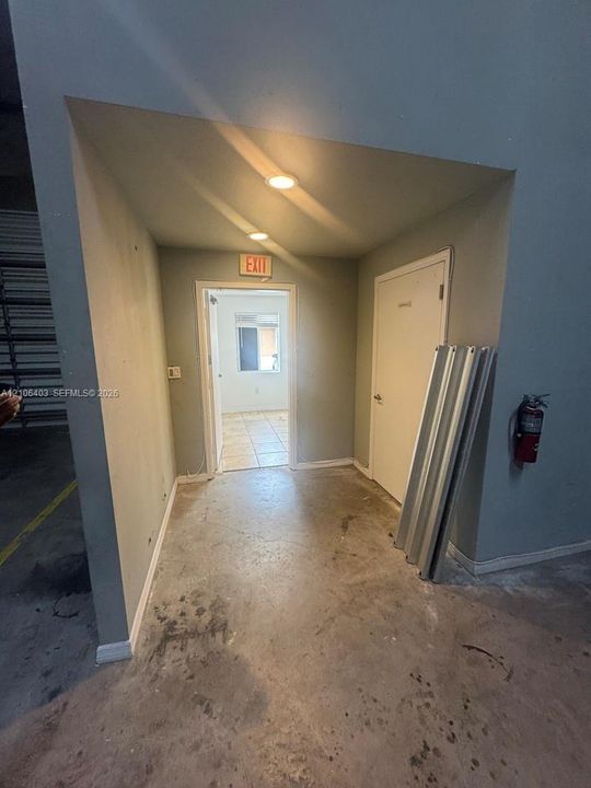 Concrete flooring, recessed ceiling lighting, and a fire extinguisher