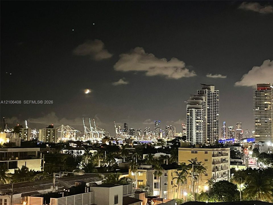 Panoramic skyline backdrop featuring illuminated high-rise towers and metropolitan infrastructure