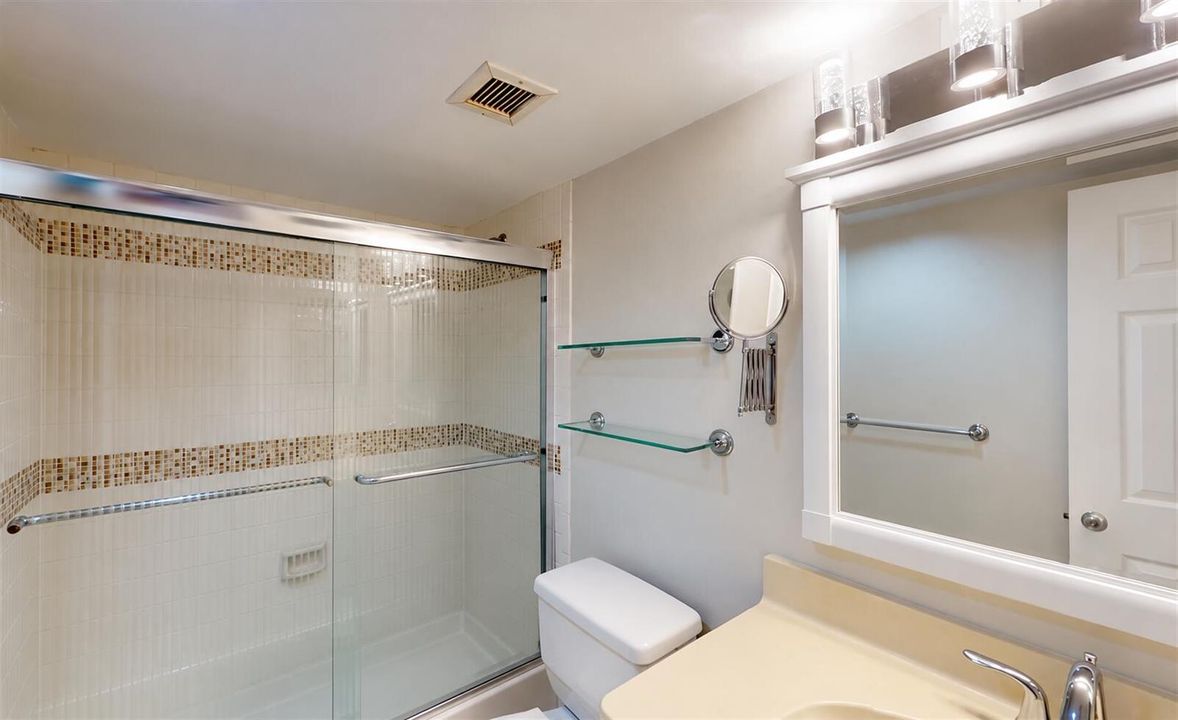 Spotless bathroom with clear shelves and