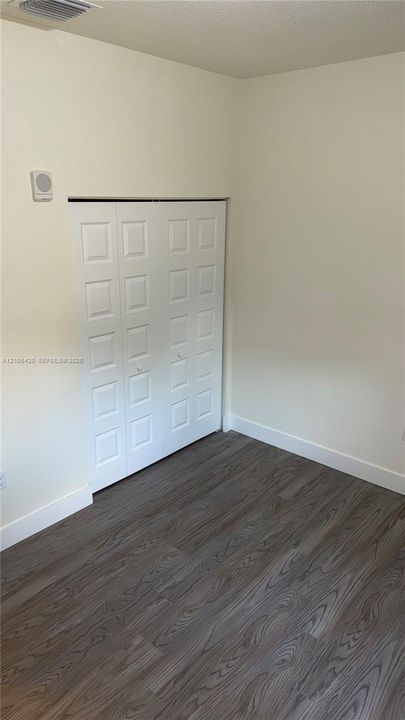 Interior space featuring wood-finish flooring and a white paneled closet door