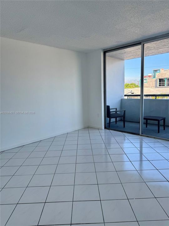 Ceramic tile flooring, sliding glass door, and private balcony