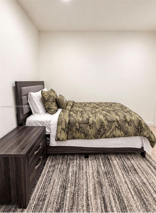 Neutral-toned interior space featuring light-colored walls and wood-finish flooring
