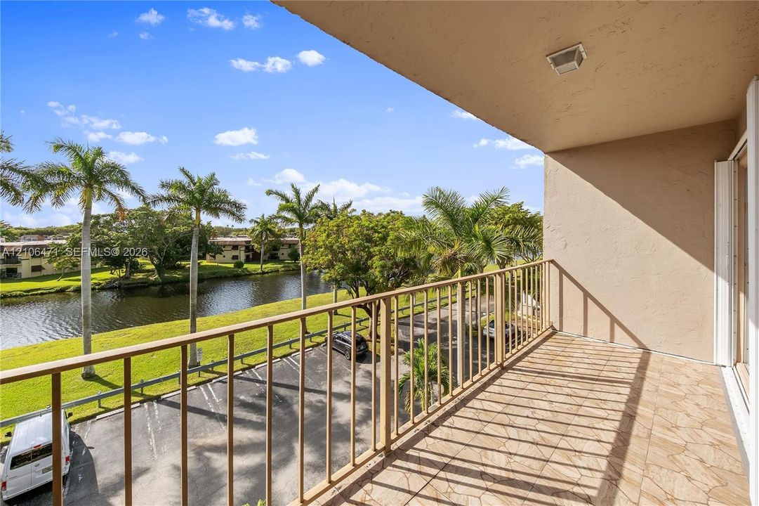 Covered balcony featuring tile flooring and metal railings