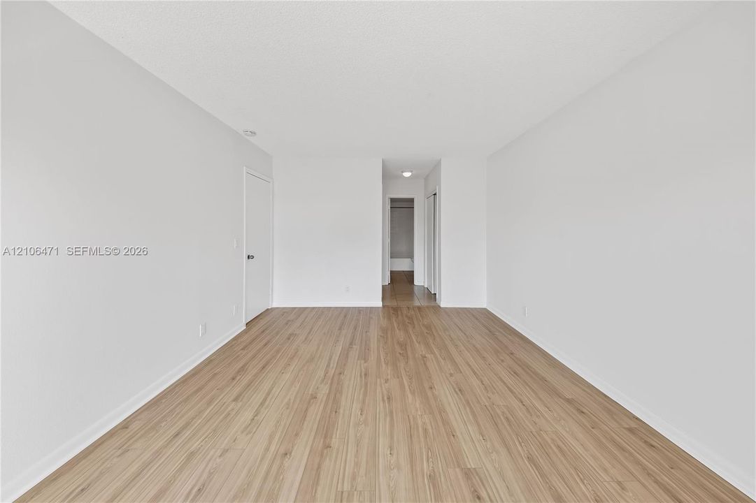 Room featuring wood-finish flooring, neutral walls, and recessed lighting