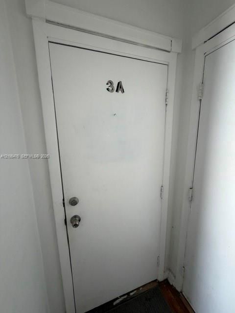 Solid-core entry door featuring a polished metal deadbolt and matching handle set