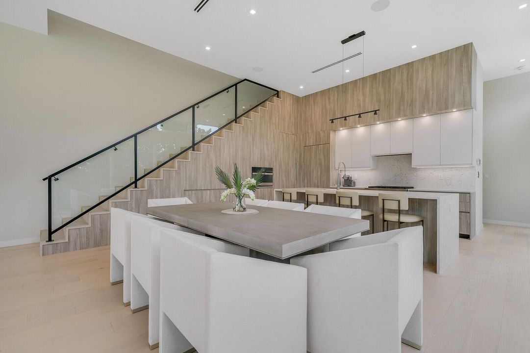 Modern Dining with Glass Staircase