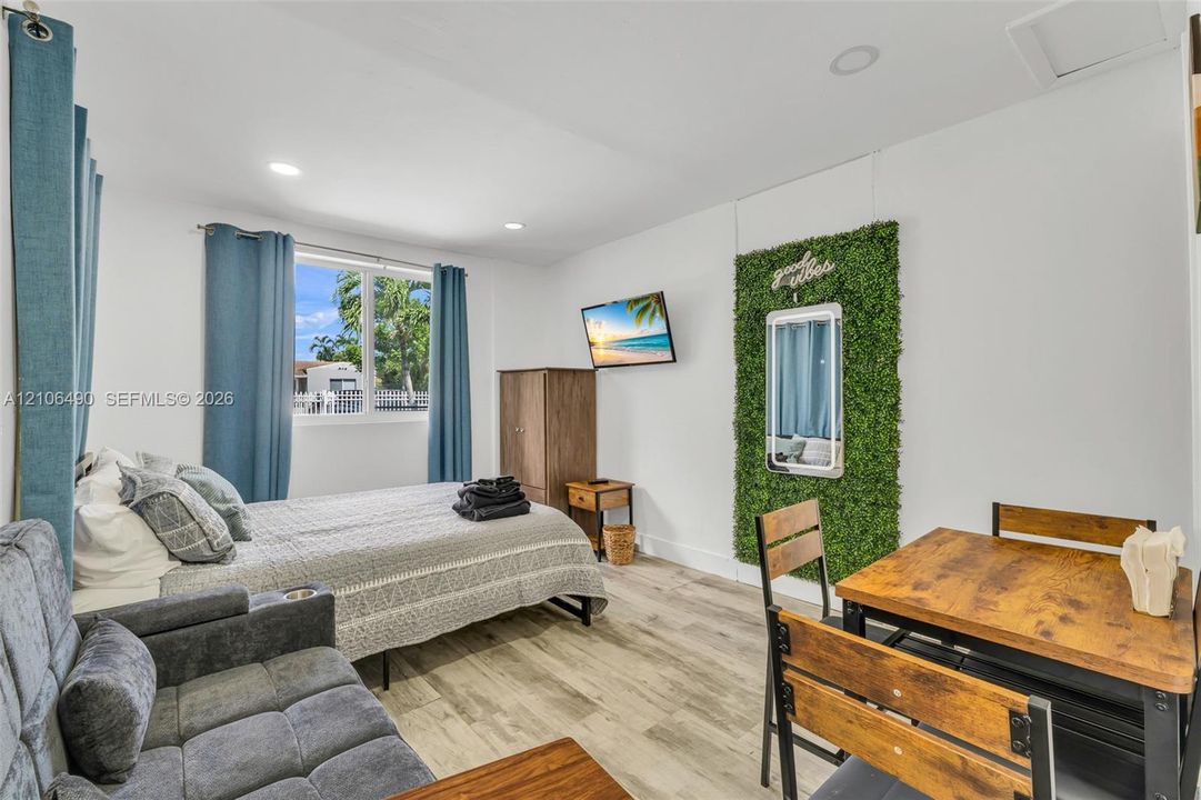 Wood-finish flooring, recessed lighting, and a large window with exterior exposure