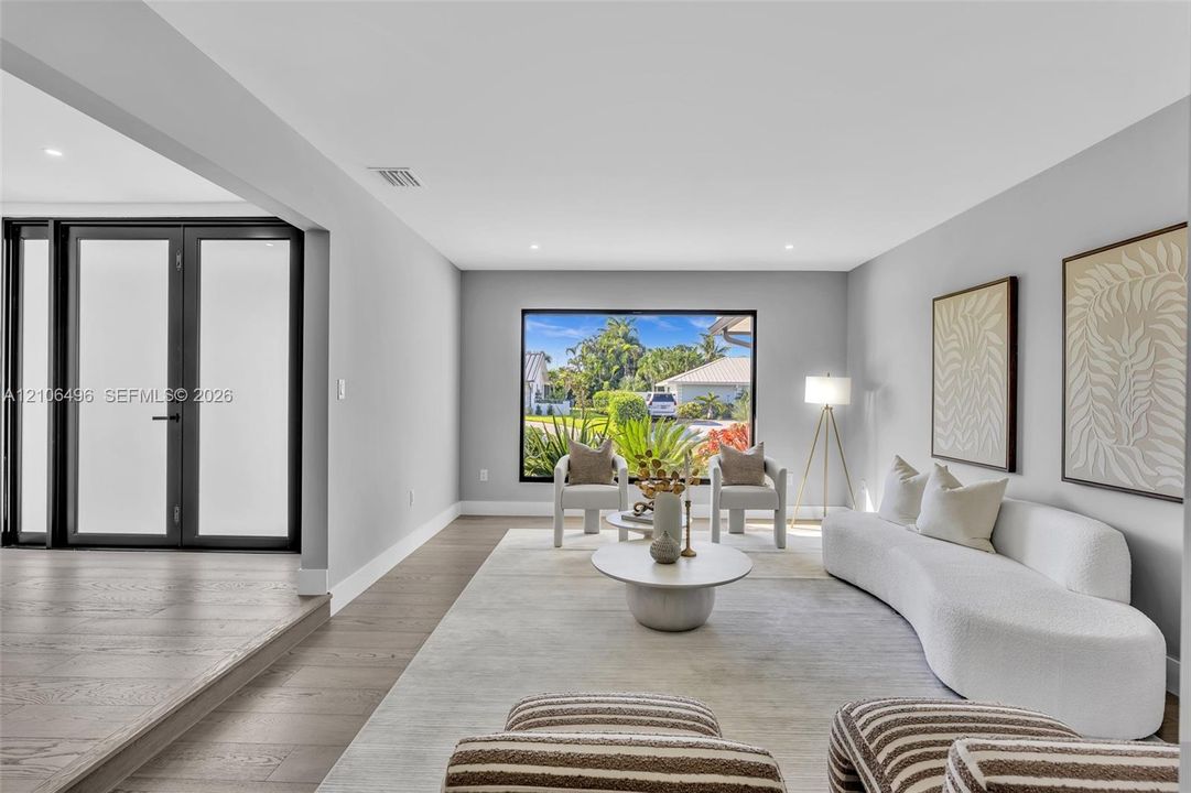Living area featuring wood-finish flooring, recessed lighting, and large picture window with exterior scenery