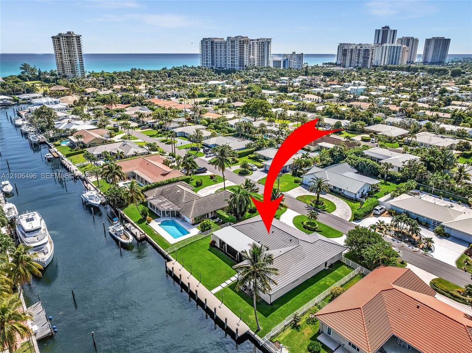 Waterfront property featuring a private boat dock, rectangular swimming pool, and concrete-tile roofing