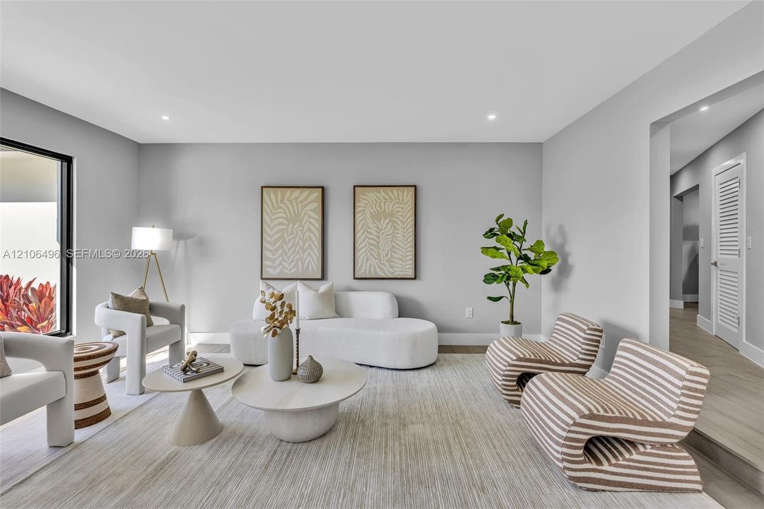 Neutral interior space featuring wood-finish flooring, recessed lighting, and a large floor-to-ceiling glass panel door