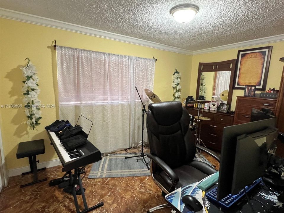 Room featuring patterned tile flooring, crown molding, and a flush-mount ceiling light fixture